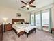 Relaxing main bedroom with a ceiling fan, soft carpet, natural light, and calming color palette at 8024 Carolina Lakes Way, Fort Mill, SC 29707