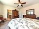 Spacious main bedroom with a ceiling fan, soft carpet, and a glimpse into the ensuite bathroom at 8024 Carolina Lakes Way, Fort Mill, SC 29707
