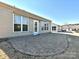 Home's back patio with a lovely brick design, surrounded by well kept yard at 8024 Carolina Lakes Way, Fort Mill, SC 29707