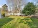 Landscaped backyard with grassy area and white picket fence at 813 Garbow Ct, Charlotte, NC 28270