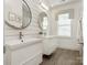 Bright bathroom with double sinks, modern floating vanities, and a large mirror at 813 Garbow Ct, Charlotte, NC 28270