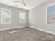 Spacious bedroom with neutral decor, carpet flooring, and multiple windows at 813 Garbow Ct, Charlotte, NC 28270