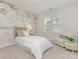 Charming bedroom featuring a whimsical mural, window shutters, and a cozy sitting area at 813 Garbow Ct, Charlotte, NC 28270