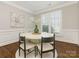 Dining room with hardwood floors, round dining table, and large windows at 813 Garbow Ct, Charlotte, NC 28270