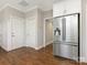 Kitchen with stainless steel refrigerator and hardwood floors at 813 Garbow Ct, Charlotte, NC 28270