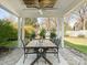 Covered patio with a wooden dining table and seating for outdoor entertaining at 813 Garbow Ct, Charlotte, NC 28270