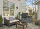 Relaxing patio with seating area, outdoor grill, and a stone retaining wall at 813 Garbow Ct, Charlotte, NC 28270