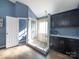 Spa-like bathroom with walk-in shower, pebble floor, and dark wood cabinets at 8440 Mossy Cup Trl, Harrisburg, NC 28075