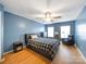 Bedroom with hardwood floors, ceiling fan, and window seat at 8440 Mossy Cup Trl, Harrisburg, NC 28075