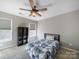 Bright bedroom with a comfy bed and built-in shelving at 8440 Mossy Cup Trl, Harrisburg, NC 28075