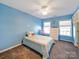 Light blue bedroom with ceiling fan and ample natural light at 8440 Mossy Cup Trl, Harrisburg, NC 28075