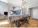 Charming dining area with a rustic wooden table and modern metal chairs at 8440 Mossy Cup Trl, Harrisburg, NC 28075