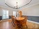 Elegant dining room with hardwood floors and a chandelier at 8440 Mossy Cup Trl, Harrisburg, NC 28075