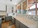 Bright kitchen with white cabinets, gray lower cabinets, and a large quartz countertop at 8440 Mossy Cup Trl, Harrisburg, NC 28075