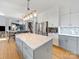 Modern kitchen features white and gray cabinets, quartz countertops, and stainless steel appliances at 8440 Mossy Cup Trl, Harrisburg, NC 28075