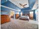 Main bedroom with carpeted floor, high ceiling, and ensuite bathroom at 8440 Mossy Cup Trl, Harrisburg, NC 28075