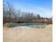 Freeform pool with stone accents and fountains at 8440 Mossy Cup Trl, Harrisburg, NC 28075