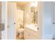 Clean bathroom with shower/tub combo, white vanity, and floral shower curtain at 9009 Powder Works Dr, Huntersville, NC 28078