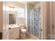 Simple bathroom with white vanity and floral shower curtain at 9009 Powder Works Dr, Huntersville, NC 28078