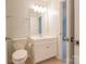 Bright bathroom featuring a toilet, sink, and vanity with shaker style cabinets at 9009 Powder Works Dr, Huntersville, NC 28078