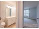 Well-lit bathroom featuring a vanity with sink, toilet, and an adjoining room at 9009 Powder Works Dr, Huntersville, NC 28078