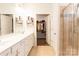 Bathroom featuring double sink vanity, tile flooring, and walk-in closet at 9009 Powder Works Dr, Huntersville, NC 28078