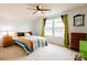 Bright bedroom with queen bed, ceiling fan, and colorful decor at 9009 Powder Works Dr, Huntersville, NC 28078