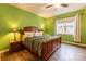 Green-walled bedroom with wooden bed frame and ceiling fan at 9009 Powder Works Dr, Huntersville, NC 28078