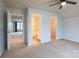 Bedroom featuring neutral carpeting, ceiling fan, and multiple door openings at 9009 Powder Works Dr, Huntersville, NC 28078