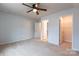 Bedroom featuring neutral carpeting, ceiling fan, with door openings to closets at 9009 Powder Works Dr, Huntersville, NC 28078