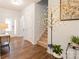 Bright and airy foyer with hardwood floors and elegant light fixture at 9009 Powder Works Dr, Huntersville, NC 28078