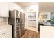 Kitchen with stainless steel fridge opens up into a laundry area at 9009 Powder Works Dr, Huntersville, NC 28078