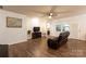 Bright living room features hardwood-style floors, a ceiling fan, and a decorative tree at 9009 Powder Works Dr, Huntersville, NC 28078