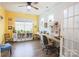 Home office features yellow walls, hardwood floors, and abundant natural light at 9009 Powder Works Dr, Huntersville, NC 28078