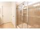 Large shower with glass enclosure and neutral tile at 9009 Powder Works Dr, Huntersville, NC 28078