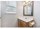 Small bathroom with single vanity and wood cabinets at 9022 Belle Bragg Way, Charlotte, NC 28214