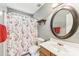 Clean bathroom with oval mirror and wood vanity at 9022 Belle Bragg Way, Charlotte, NC 28214