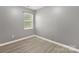 Simple bedroom with gray walls and wood-look floors at 9022 Belle Bragg Way, Charlotte, NC 28214