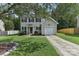 Two-story house with gray siding, a white door, and a two-car garage at 9022 Belle Bragg Way, Charlotte, NC 28214