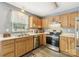 Kitchen with wooden cabinets and stainless steel appliances at 9022 Belle Bragg Way, Charlotte, NC 28214