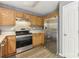 Modern kitchen with stainless steel appliances and wood cabinets at 9022 Belle Bragg Way, Charlotte, NC 28214