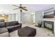 Living room with brown sectional sofa and fireplace at 9022 Belle Bragg Way, Charlotte, NC 28214