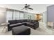 Living room with brown sectional sofa and view into kitchen at 9022 Belle Bragg Way, Charlotte, NC 28214