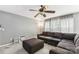 Living room with brown sectional sofa, ottoman, and ceiling fan at 9022 Belle Bragg Way, Charlotte, NC 28214