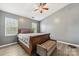 Spacious main bedroom with wood bed frame and ceiling fan at 9022 Belle Bragg Way, Charlotte, NC 28214