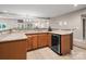 Basement wet bar with wine cooler and cabinets at 9117 Monarchos Ct, Waxhaw, NC 28173