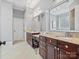 Double vanity bathroom with dark brown cabinets at 9117 Monarchos Ct, Waxhaw, NC 28173