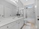 Bathroom with white vanity and marble shower surround at 9117 Monarchos Ct, Waxhaw, NC 28173