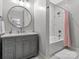 Bathroom with grey vanity, bathtub, and pink shower curtain at 9117 Monarchos Ct, Waxhaw, NC 28173