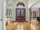 Grand entryway with hardwood floors and elegant double doors at 9117 Monarchos Ct, Waxhaw, NC 28173